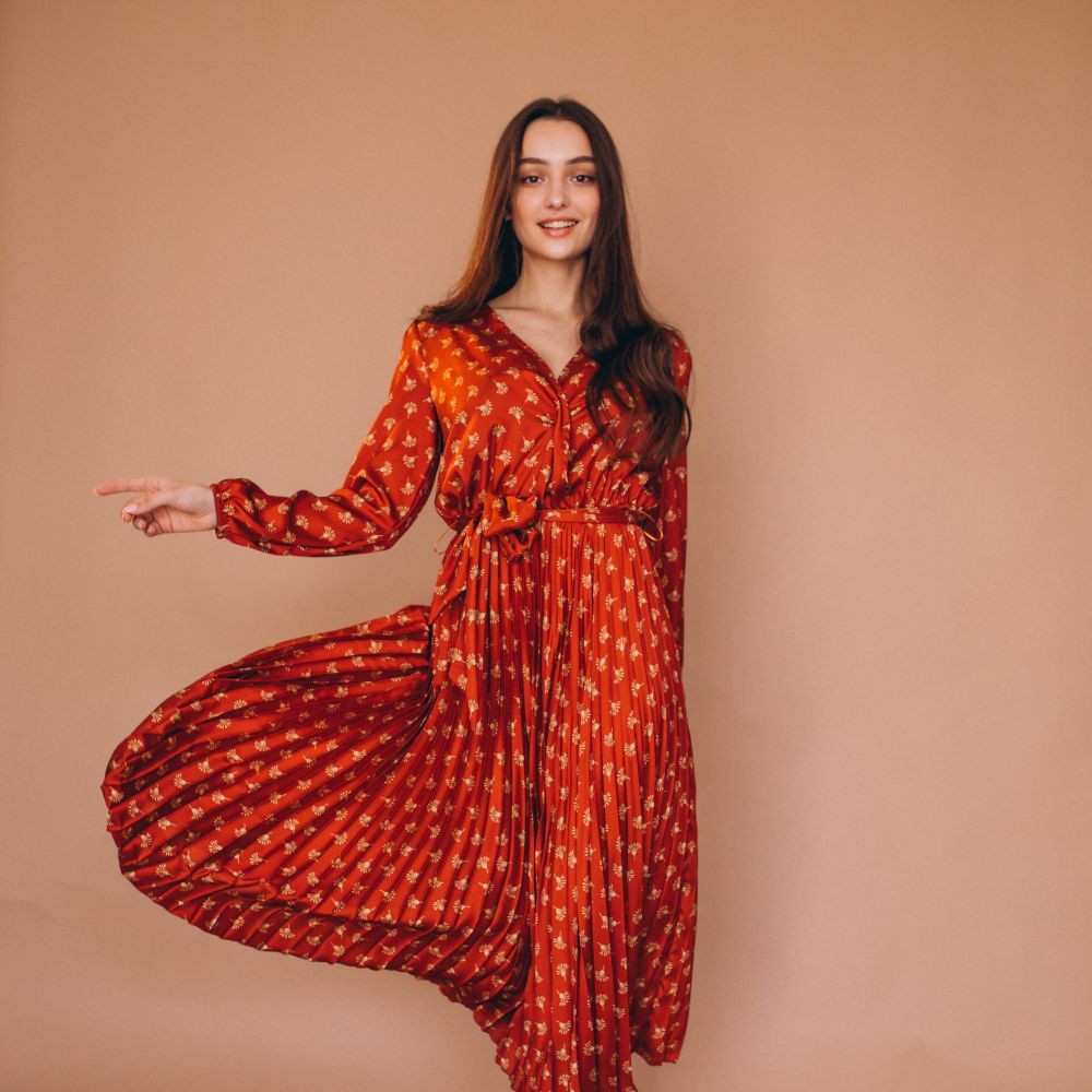 Young woman in a beautiful red dress in studio