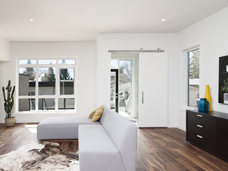 A beautiful interior shot of a modern house with white relaxing walls and furniture and technology