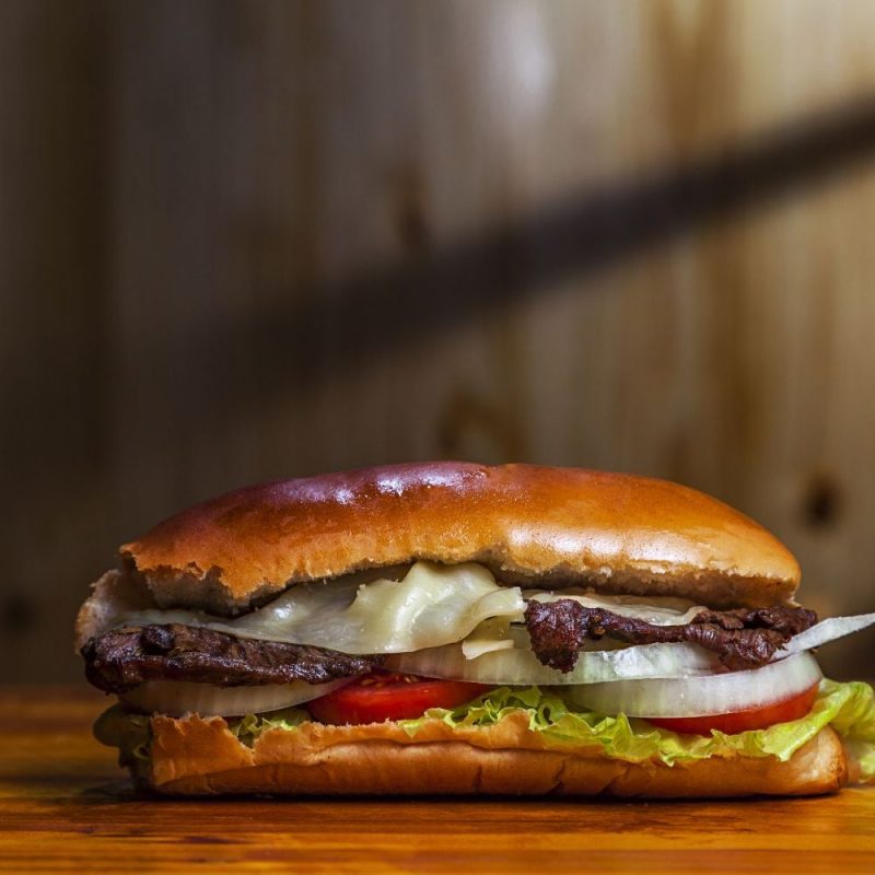 A closeup shot of a delicious homemade Colombian hamburger on the table