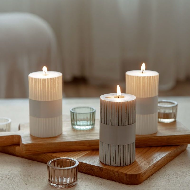 Close up of burning candles as a detail of home decor.